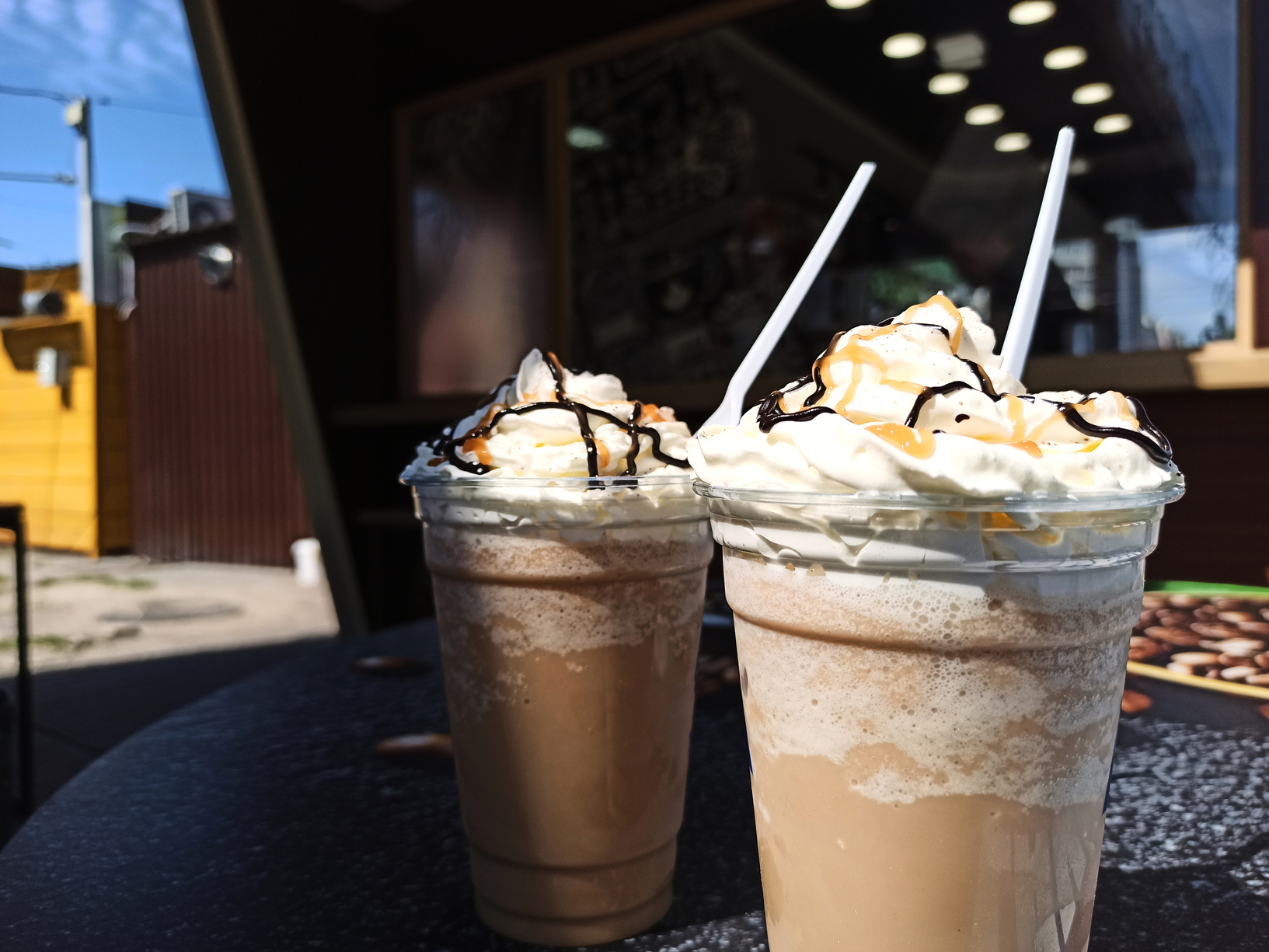 Iced caramel latte, frappe, frappucino topped with whipped cream and caramel sauce, refreshing and sweet coffee drink