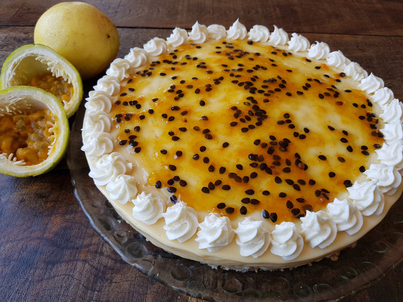 Pie or passion fruit cheesecake decorated with whipped cream and passion fruit syrup